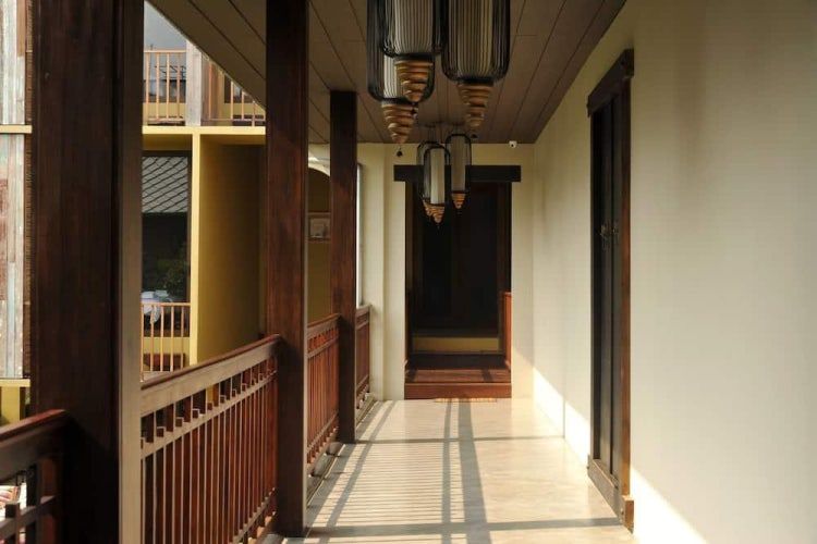 Traditional wooden hallway with Thai-style lanterns at Villa Prasumen Bangkok