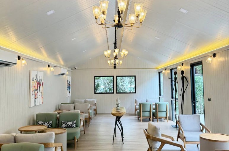 "Elegant indoor lounge with cozy chairs and chandeliers at Oasis Spa Sukhumvit 31"